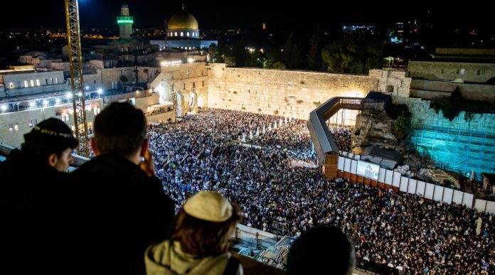 Thousands attend Selichot, or penitential prayers at the Western Wall in the Old City of Jerusalem early on Oct. 8, 2019, prior to the start of Yom Kippur. (Yonatan Sindel/Flash90)