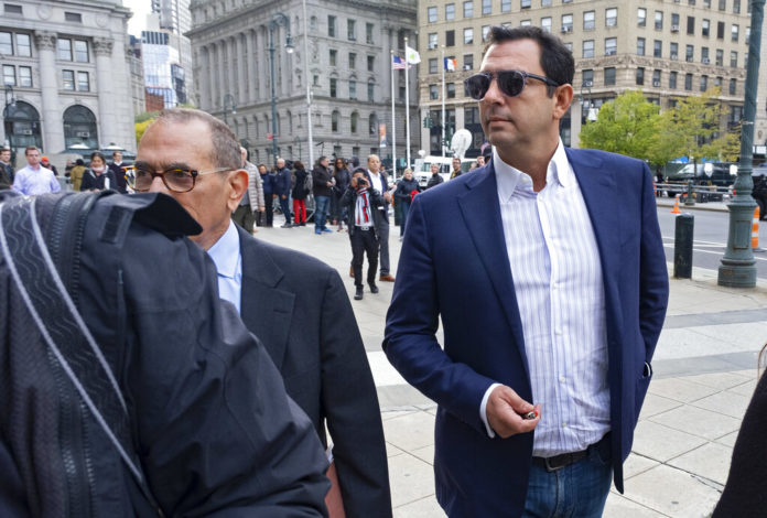 Andrey Kukushkin, right, leaves federal court, Thursday, Oct. 17, 2019, in New York. Kukushkin and David Correia pleaded not guilty Thursday to conspiring with associates of Rudy Giuliani to make illegal campaign contributions. They are among four men charged with using straw donors to make illegal contributions to politicians they thought could help their political and business interests. (AP Photo/Craig Ruttle)