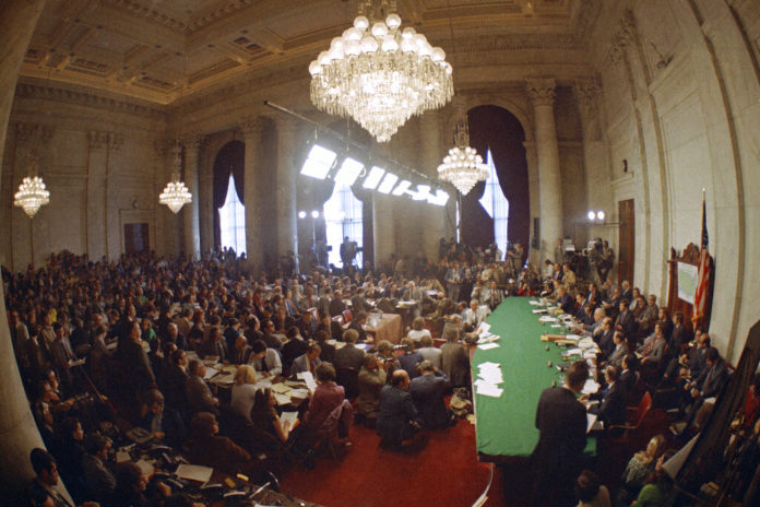 FILE - In this May 18, 1973, file photo, the hearing of the Senate select committee on the Watergate case on Capitol Hill in Washington. In 1973, millions of Americans tuned in to what Variety called "the hottest daytime soap opera" _ the Senate Watergate hearings that eventually led to President Richard Nixon's resignation. For multiple reasons, notably a transformed media landscape, there's unlikely to be a similar communal experience when the House impeachment inquiry targeting Donald Trump goes on national television starting Nov. 13, 2019. (AP Photo)
