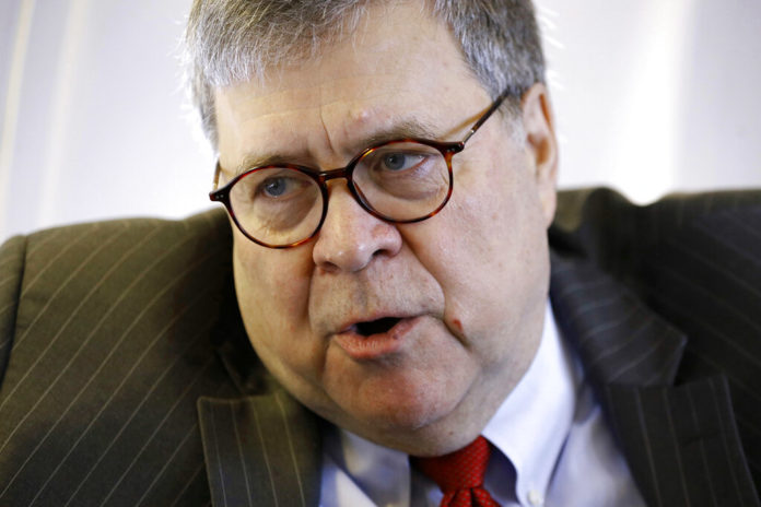 Attorney General William Barr speaks with an Associated Press reporter onboard an aircraft en route to Cleveland, Thursday, Nov. 21, 2019, during a two-day trip to Ohio and Montana. (AP Photo/Patrick Semansky)