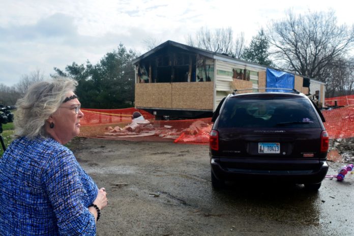 Marie Chockley, a resident of the Timberline Trailer Court, surveys the damage April 7, 2019, that was caused by a fire that killed five residents in a mobile home (Kevin Barlow, AP)