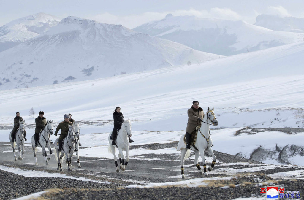 This undated photo provided on Wednesday, Dec. 4, 2019, by the North Korean government shows North Korean leader Kim Jong Un, right, and his wife Ri Sol Ju, second from right, riding on white horse during a visit to Mount Paektu, North Korea. North Korea says leader Kim has taken a second ride on a white horse to a sacred mountain in less than two months. Independent journalists were not given access to cover the event depicted in this image distributed by the North Korean government. The content of this image is as provided and cannot be independently verified. Korean language watermark on image as provided by source reads: “KCNA” which is the abbreviation for Korean Central News Agency. (Korean Central News Agency/Korea News Service via AP)