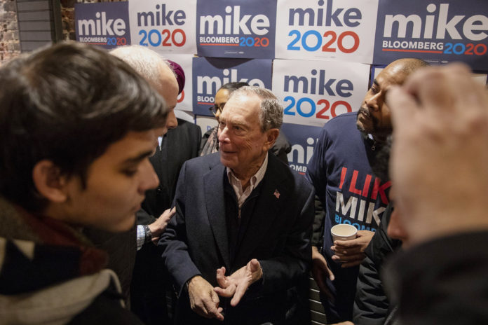 Democratic presidential candidate Michael Bloomberg walks into the crowd of supporters and volunteers to speak to them and take photos after speaking in Philadelphia on Saturday, Dec. 21, 2019. (Tyger Williams/The Philadelphia Inquirer via AP)