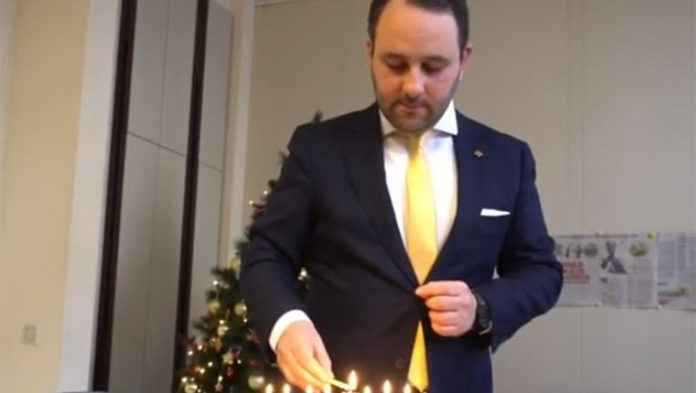 Michael Freilich lights Hanukkah candles in the Belgian Federal Parliament in Brussels, Belgium, Dec. 19, 2019. (Michael Freilich)