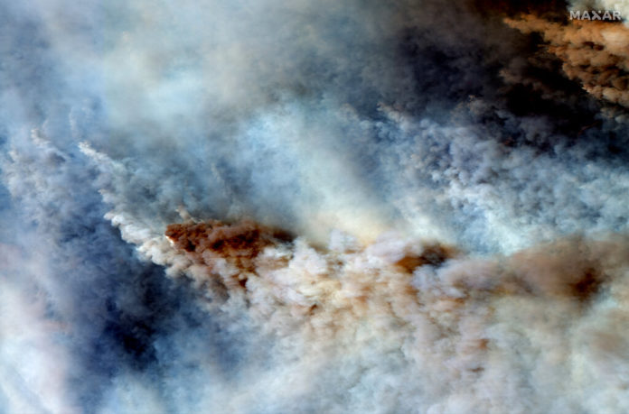 This Saturday, Jan. 4, 2019 image provided by provided by Maxar Technologies shows wildfires east of Orbost , Australia. Australia's prime minister called up about 3,000 reservists on Saturday as the threat of wildfires escalated in at least three states, while strong winds and high temperatures were forecast to bring flames to populated areas including the suburbs of Sydney. (Satellite image ©2020 Maxar Technologies via AP)