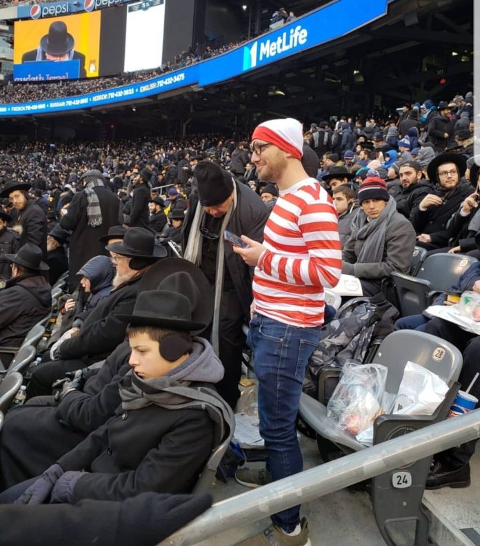 Yonatan Gray stands at the Siyum Hashas in his Waldo costume Jan 1st, 2020