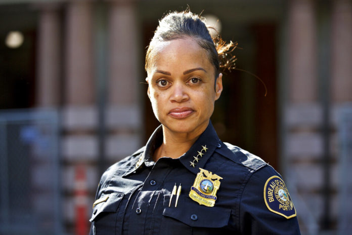 FILE - In this Aug. 5, 2019, file photo, Portland Police Chief Danielle Outlaw poses for a photo in Portland, Ore. Outlaw was named Philadelphia's new police commissioner and will start work on Monday, Feb. 10, 2020. (AP Photo/Craig Mitchelldyer, File)