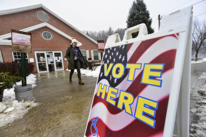 Gina Hammett, of Hinsdale, N.H., leaves the Millstream Community Center, in Hinsdale, after casting her vote in the New Hampshire presidential primary elections, Tuesday, Feb. 11, 2020. (Kristopher Radder/The Brattleboro Reformer via AP)