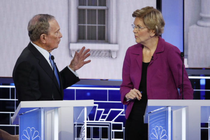 Democratic presidential candidate, former New York City Mayor Mike Bloomberg talks with Sen. Elizabeth Warren, D-Mass., during a break at a Democratic presidential primary debate Wednesday, Feb. 19, 2020, in Las Vegas, hosted by NBC News and MSNBC. (AP Photo/John Locher)