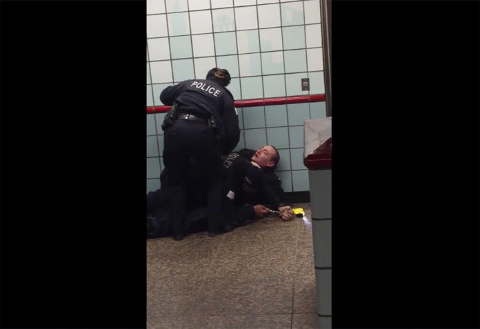 This Friday, Feb. 28, 2020 image from cellphone video shows Chicago police officers trying to apprehend a suspect inside a downtown Chicago train station. After a struggle with police, the suspect was shot as he fled up the escalator with the officers in pursuit. Mayor Lori Lightfoot said video footage of police shooting and wounding the suspect is “extremely disturbing” and that she supports the interim police superintendent's request for prosecutors to be sent directly to the scene.   (Michael McDunnah via AP)