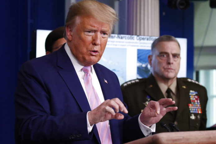 President Donald Trump speaks about the coronavirus in the James Brady Press Briefing Room of the White House, Wednesday, April 1, 2020, in Washington, as Chairman of the Joint Chiefs Gen. Mark Milley, listens. (AP Photo/Alex Brandon)