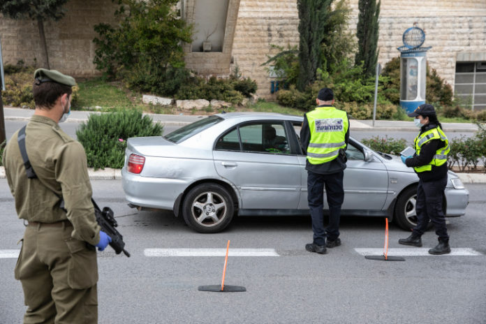 Police at a temporary "checkpoint" in Jerusalem on April 15, 2020, to check if people are not disobeying the governments orders on a lockdown, in order to prevent the spread of the Coronavirus. Photo by Olivier Fitoussi/Flash90