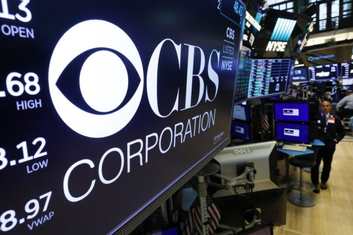 The logo for the CBS Corporation appears above a trading post on the floor of the New York Stock Exchange, Tuesday, Aug. 13, 2019 (AP Photo/Richard Drew)