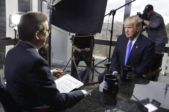 FILE - Chris Wallace, of "Fox News Sunday," left, interviews president-elect Donald Trump on Dec. 10, 2016 in New York. Two veteran journalists who now teach the craft say Wallace's interview with President Donald Trump on Sunday will be an example of excellence that they show their students. The interview, where Wallace asked the president some blunt questions and challenged some facts, was seen as an example of what can result from hard work and preparation. (AP Photo/Richard Drew, File)