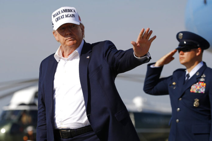 President Donald Trump waves as he steps off Air Force One at Andrews Air Force Base, Md., Sunday, July 26, 2020. Trump is returning to Washington after spending the weekend at his golf club in Bedminster, N.J. (AP Photo/Patrick Semansky)