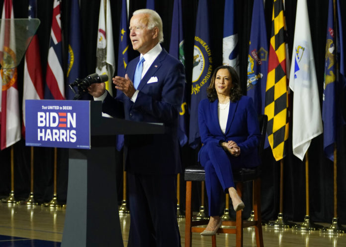 Democratic presidential candidate former Vice President Joe Biden, joined by his running mate Sen. Kamala Harris, D-Calif., speaks during a campaign event at Alexis Dupont High School in Wilmington, Del., Wednesday, Aug. 12, 2020. (AP Photo/Carolyn Kaster)