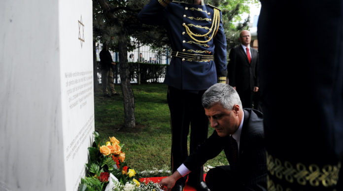 Kosovo Prime Minister Hashim Thaci places flowers in Pristina, May 23, 2013, on the commemorative plaque remembering Kosovo Jews that perished in Holocaust, at the site where the last synagogue of Kosovo stood until 1963. (Armend Nimani/AFP via Getty Images)