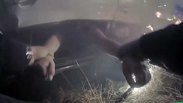 Watch: Police Officer Pulls Woman From Burning Car 1