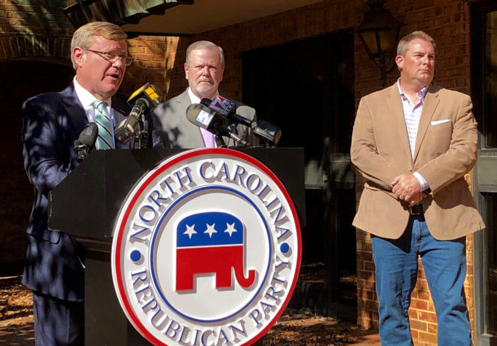 North Carolina House Speaker Tim Moore, left, R-Cleveland, speaks to reporters, with Senate leader Phil Berger, R-Rockingham, and House Majority Leader John Bell, right, R-Wayne, at a news conference on Wednesday, Nov. 4, 2020 at state GOP headquarters in Raleigh, N.C., to discuss Election Day results (AP Photo/Gary D. Robertson).