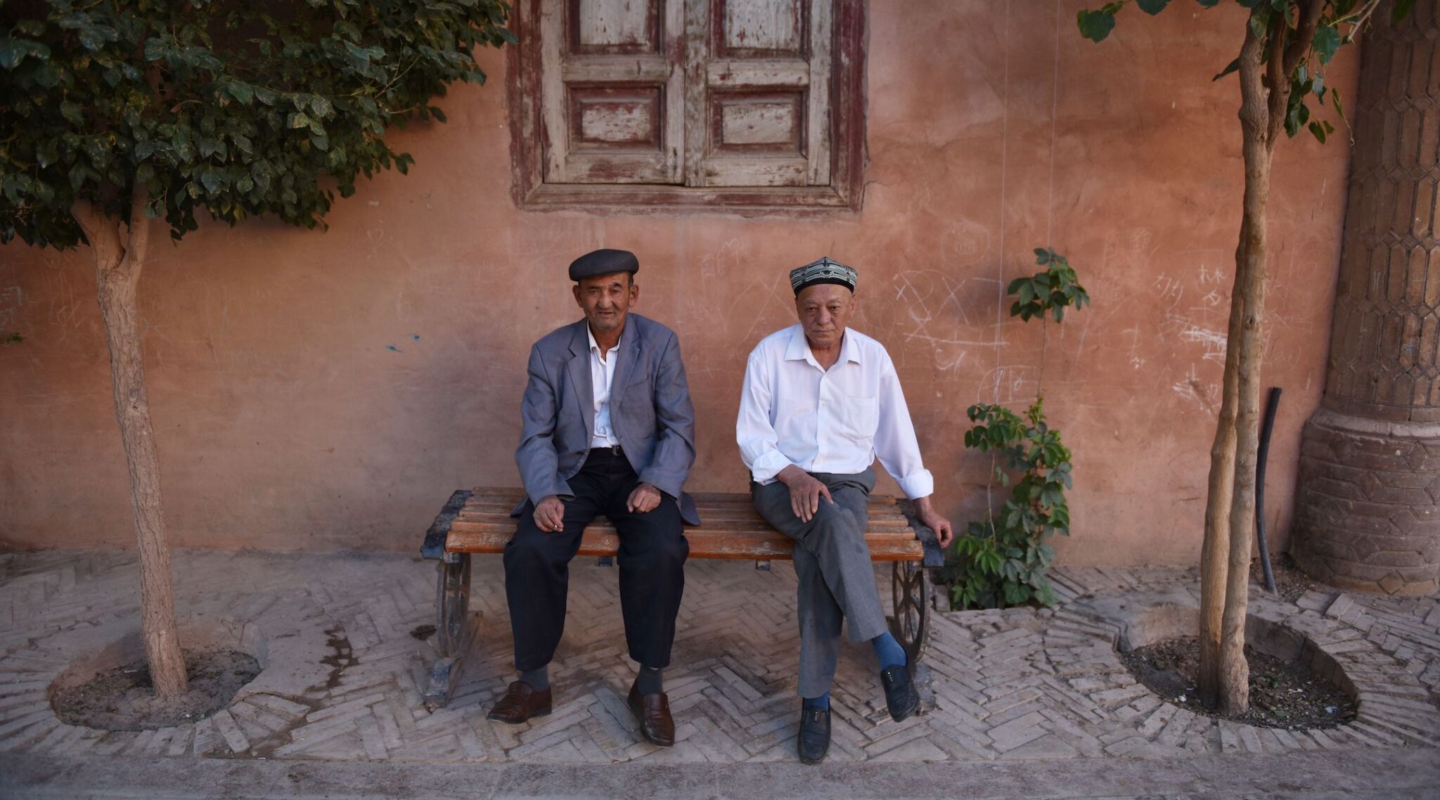 Uighur men rest in the restored old city area of Kashgar, in China’s western Xinjiang region, in 2019. (Greg Baker/AFP via Getty Images)