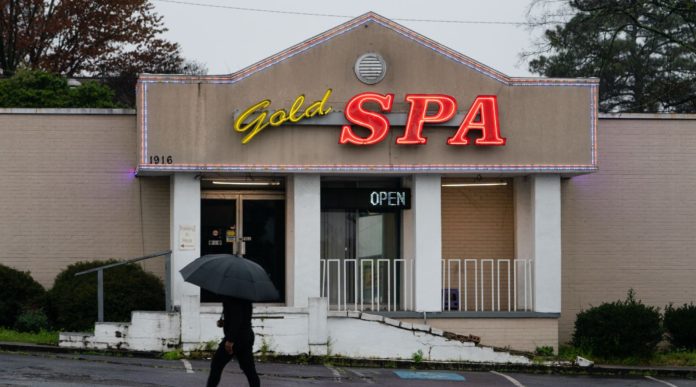 A man walks past a massage parlor where three women were shot and killed in Atlanta, March 17, 2021. (Elijah Nouvelage/Getty Images)
