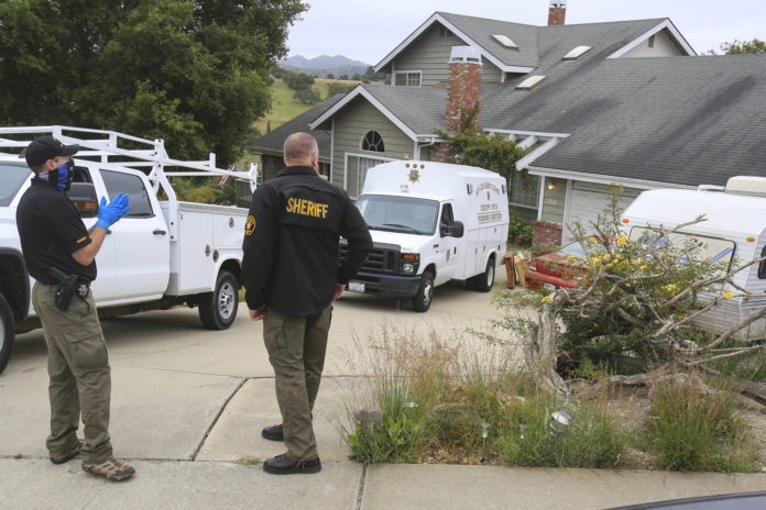 Investigators with the San Luis Obispo County Sheriff Department returned to the house of Reuben Flores Tuesday, April 13, 2021, in Arroyo Grande, Calif. The backyard was marked with crime scene tape as they search for missing Cal Poly student Kristin Smart at the Arroyo Grande house. San Luis Obispo County Sheriff's Office is searching the Arroyo Grande home of Ruben Flores under a warrant. Ruben is the father of Paul Flores, the sole person of interest in missing Cal Poly student Kristin Smart's disappearance. (David Middlecamp/The Tribune (of San Luis Obispo) via AP)