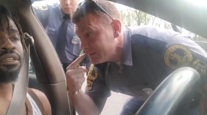 After a cell phone video of an April 2019 traffic stop in Fairfax County was shared by a civil rights lawyer earlier this week, Virginia State Police have opened a criminal investigation. This still shot of the video shows the trooper who's under investigation, Charles Hewitt, and the victim, Derrick Thompson. (Courtesy photo)