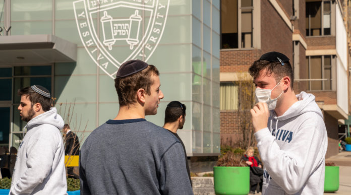 NEW YORK, NY - MARCH 4: A Yeshiva student wears a face mask on the grounds of the university on March 4, 2020 in New York City. A Yeshiva student has tested positive for Covid-19. The student's father was the¬†second person¬†to test¬†positive for Covid-19 in New York and is currently hospitalized. (Photo by David Dee Delgado/Getty Images)